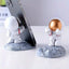 3D Astronaut Phone Holder – Unique Planet-Inspired Mobile Stand with Fun, Playful Design for Desk or Home Use (1 Pc)