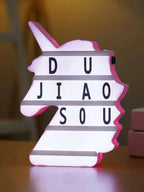 Unicorn-Shaped LED Message Box A battery/USB-powered LED backlight sign shaped like a unicorn profile, featuring integrated horizontal slots to slide in customizable letters, numbers, and symbols.